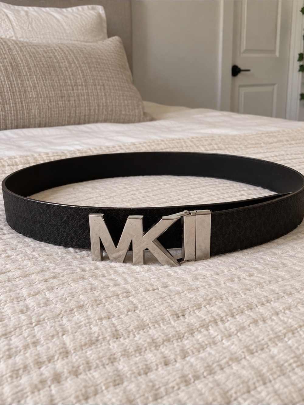 Michael Kors black belt with a bold silver MK buckle 🖤✨